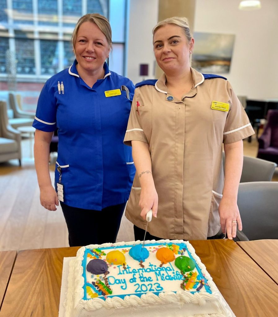 Jenny Reed and Claire Lisle cutting International Day of the Midwife cake