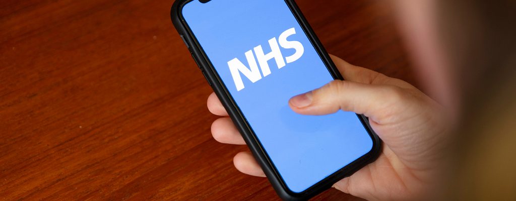 Person using the NHS App on their mobile phone
