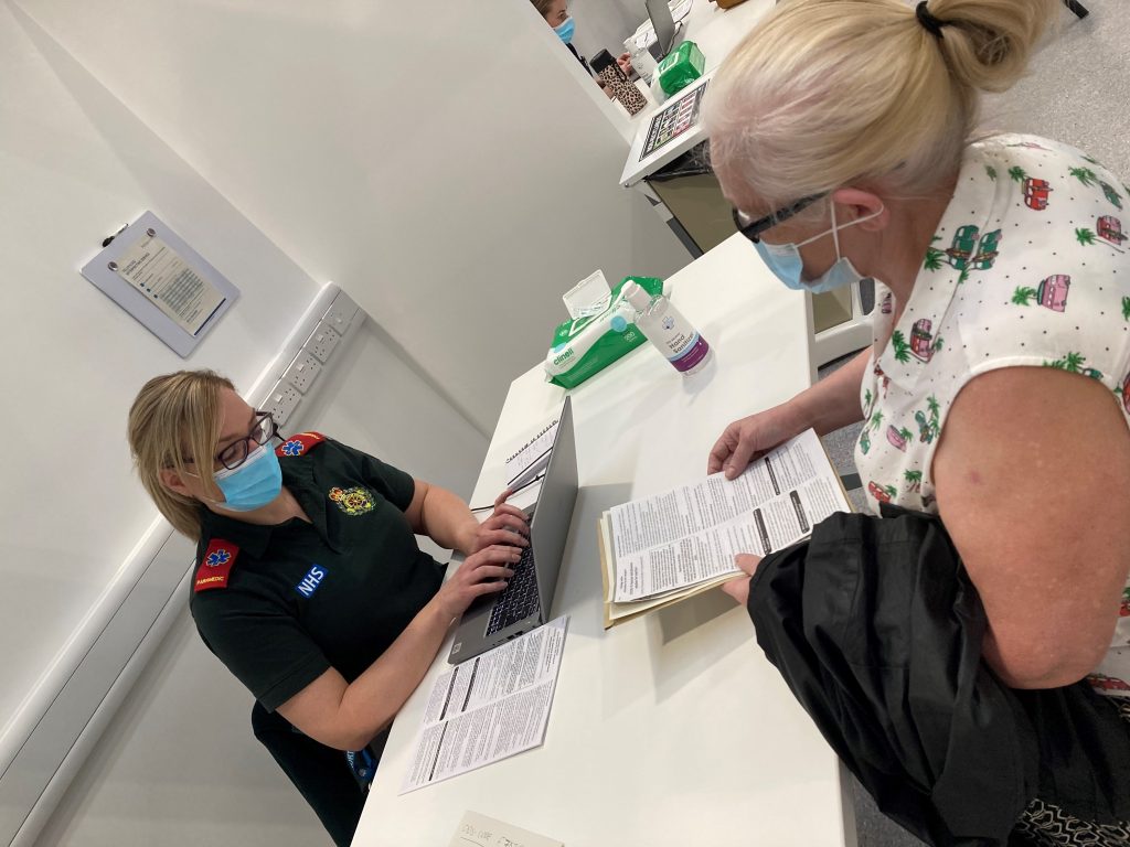 COVID-19 vaccination patient being assessed by a member of the North East Ambulance Service