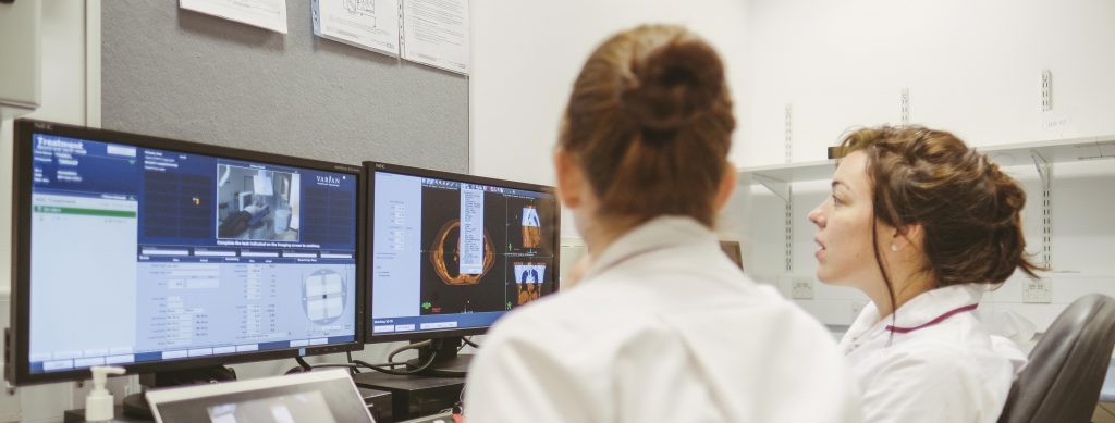 Radiographers watching a patient receiving their radiotherapy treatment at the Northern Centre for Cancer Care