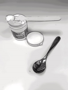 Picture of a spatula with cream out of a tub of emollient and a spoon alongside it.