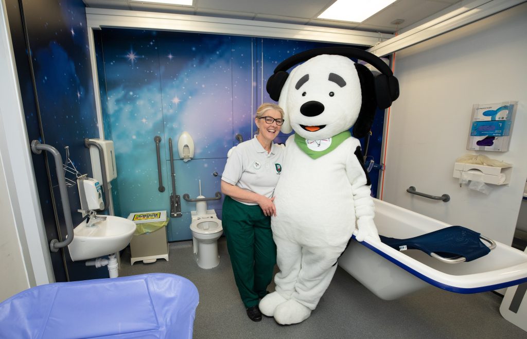 Cheryl Gascoigne and Bobby our sensory mascot in one of our revamped bathrooms