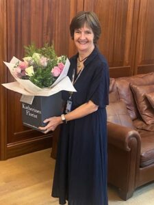 Dr Clare Abley with a gift of flowers at her retirement