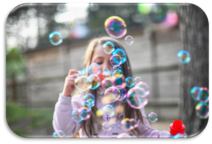 Photo of a child blowing bubbles