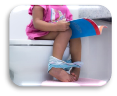 Image of a child on the toilet reading a book