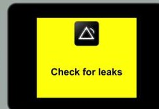 MY Airvo 2 screen with the message 'check for leaks' on yellow background with black square and white triangle in it.