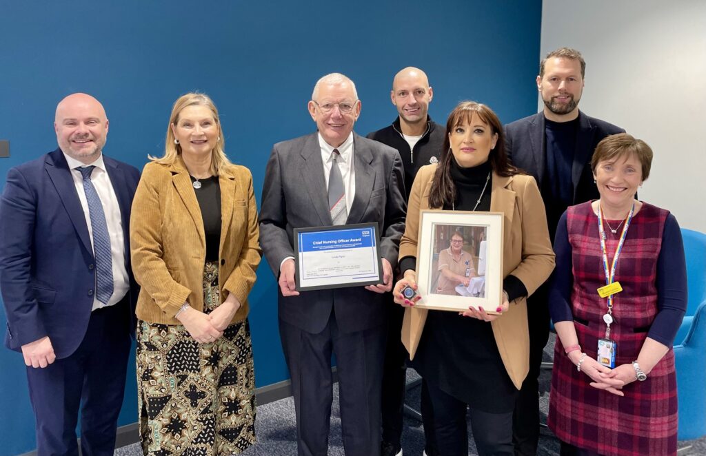 Duncan Burton Deputy Chief Nursing Officer for England with Linda Flynn's Family and Executive Chief Nurse Maurya Cushlow