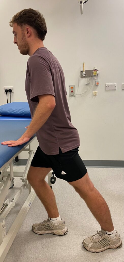 Person in the walking stance with the leg to be stretched straight out behind you and the other leg in front of you with your front knee bent.