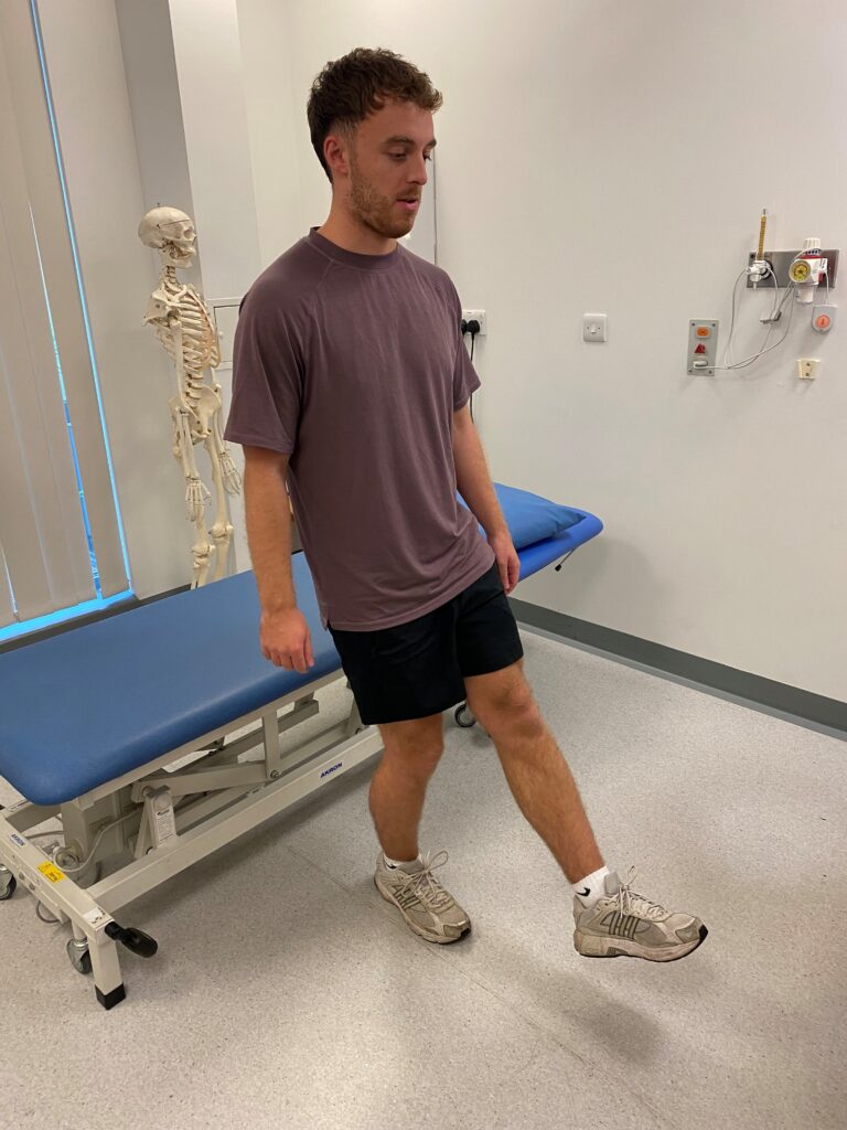 Person stood on one leg bent with one left straight out in front of them.