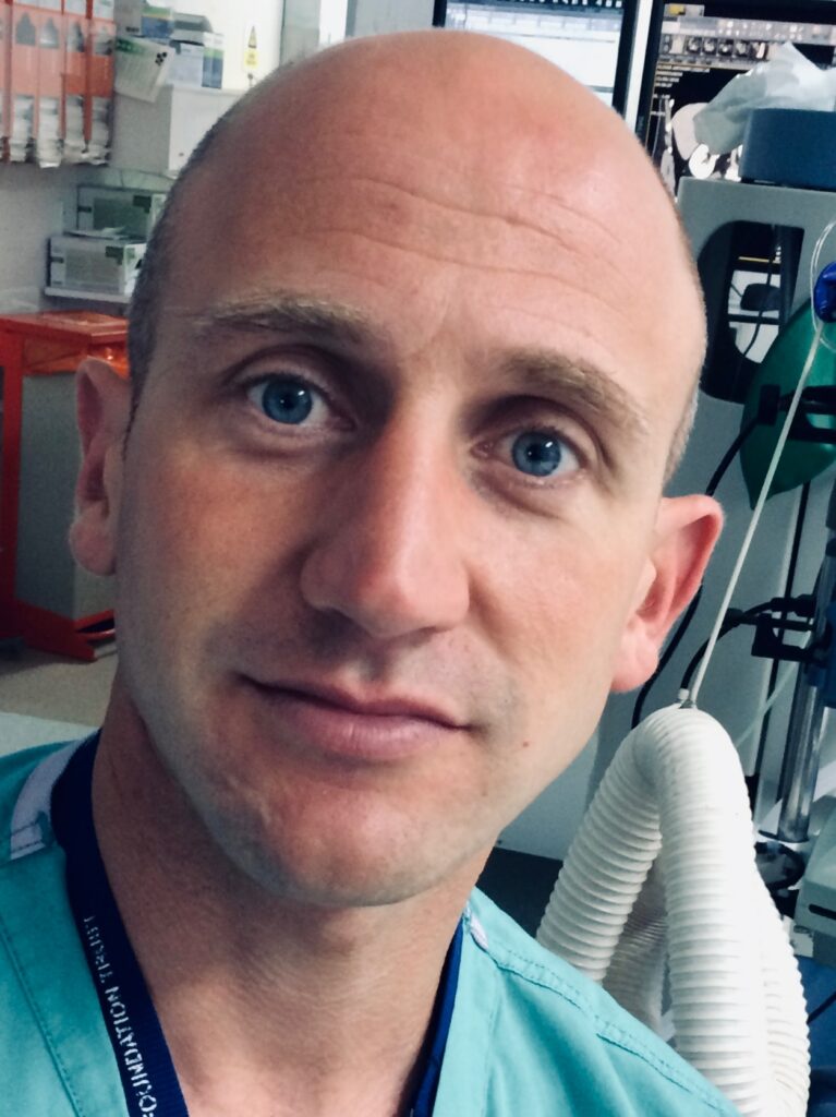 A headshot of Mr Toby Page in a hospital room 