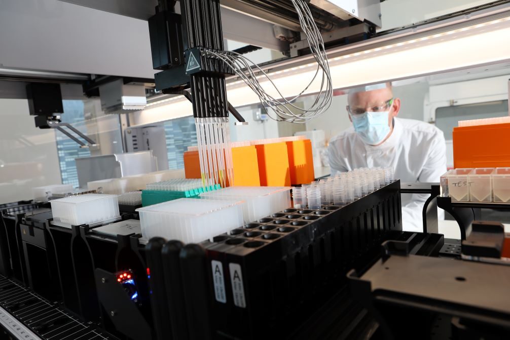 Press Principal scientist Simon looking through equipment