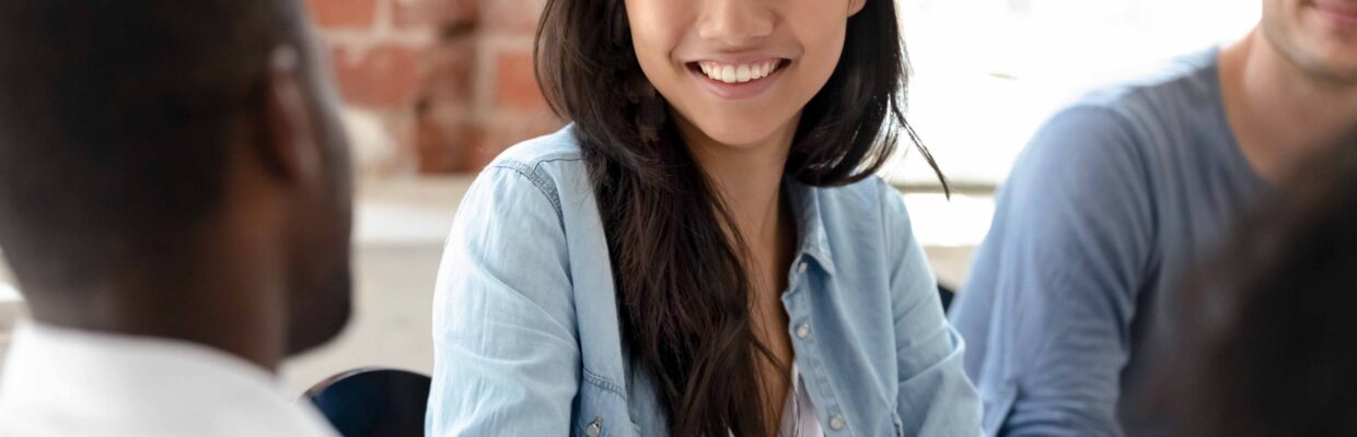 Smiling asian businesswoman handshaking african businessman at professional business meeting, diverse team workers shaking hands expressing respect welcoming new employee at group office teamwork