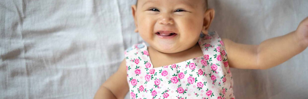 A baby in a floral dress