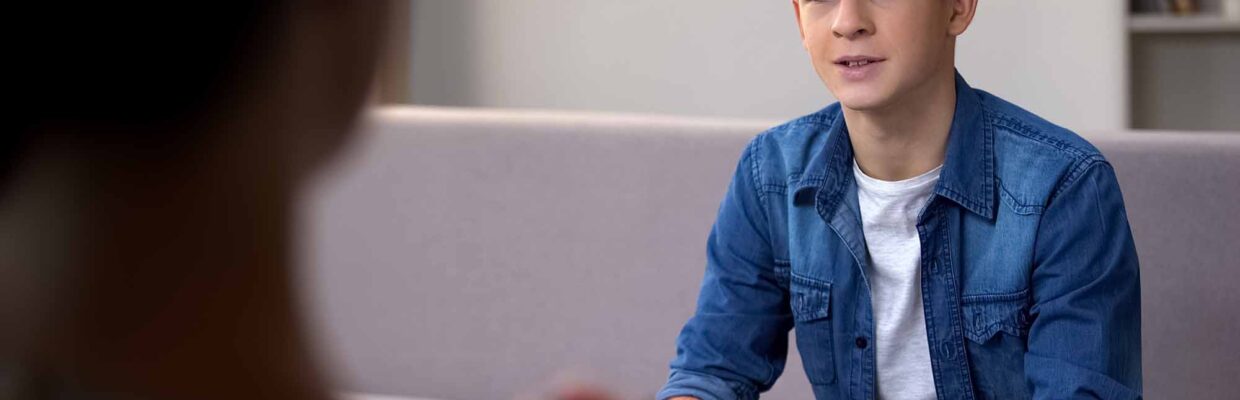 A young man in discussion with a health professional