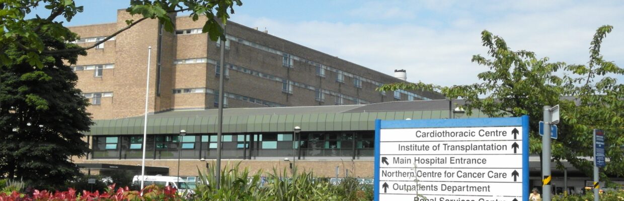 A exterior photo of the Freeman Hospital and direction sign
