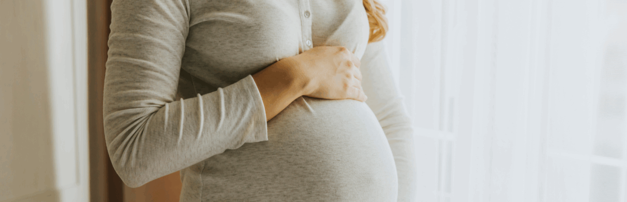 A pregnant woman holding her belly