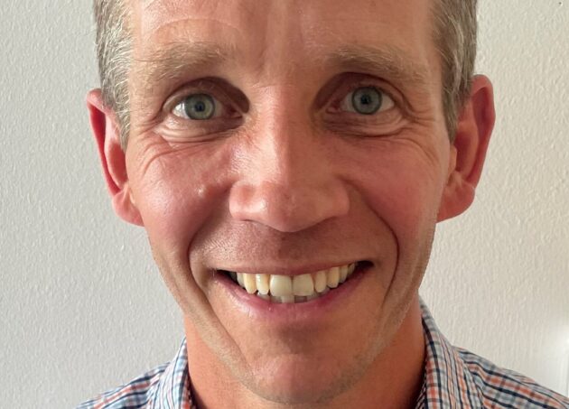 A headshot of Dr John Frew