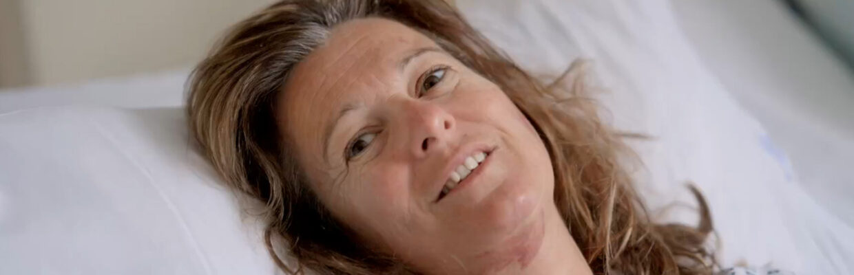 A female patient lying in a hospital bed