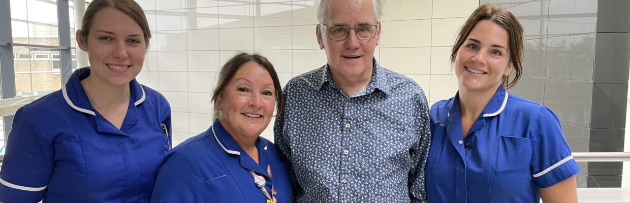 The medical professional standing with a Neil Bradshaw