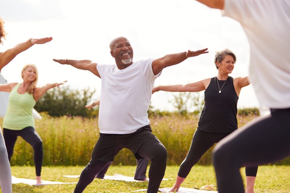 A group of people taking an outdoor yoga class