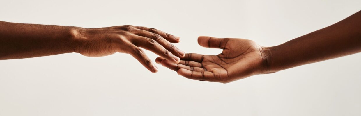Two hands reaching for each other