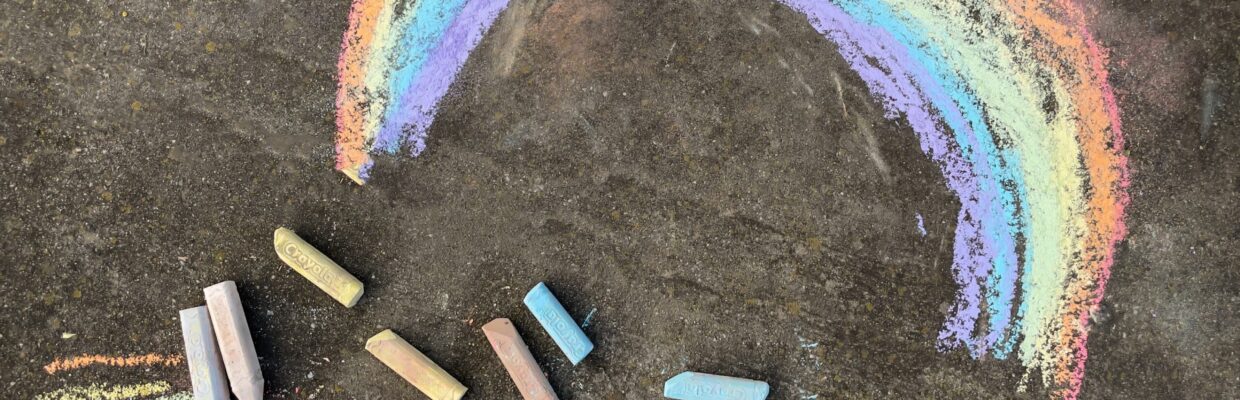 A childrens chalk picture of a rainbow