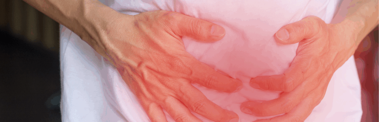 A person clutching their stomach which is highlighted red to show pain