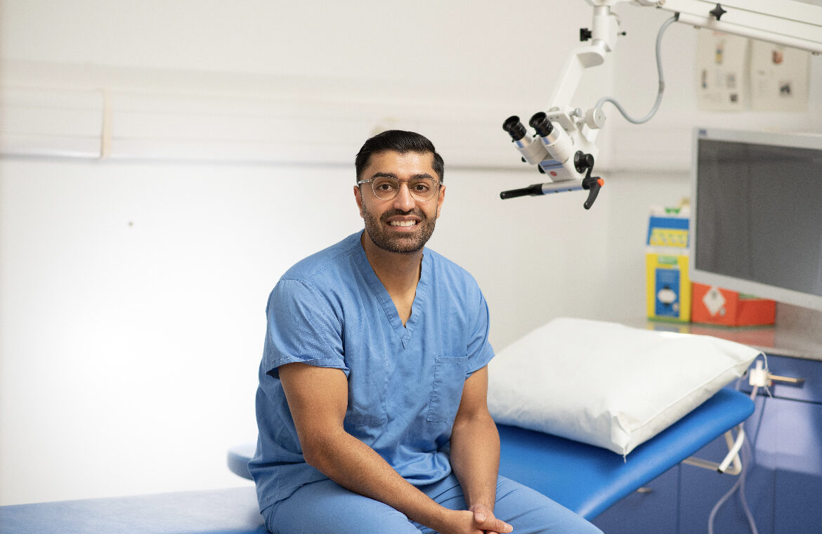 Amar Rajgor sitting on a bed in a consultation room