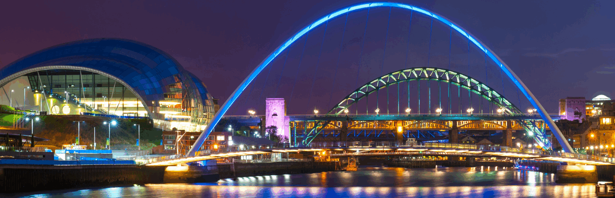 A photo of Newcastle Quayside and bridges lit up at night