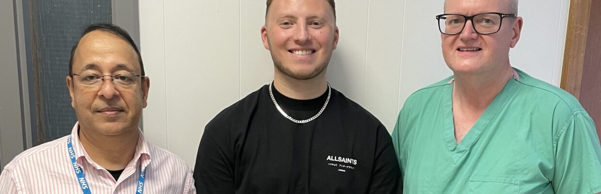 Two medical staff standing with a discharged patient