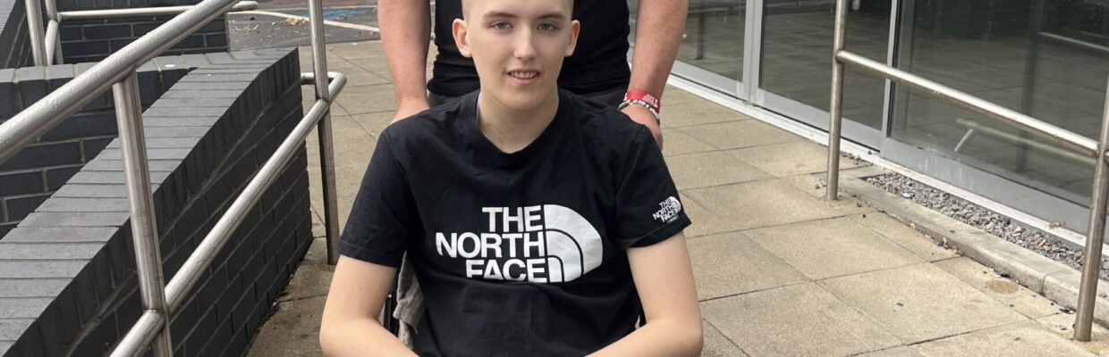 A photo of a man and his son in a wheelchair