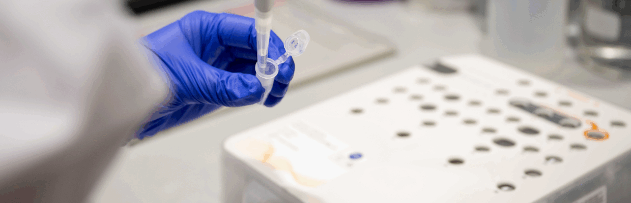 A scientist injecting something into a tube