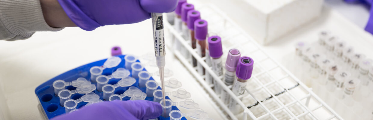 Scientist injecting something into a sealable tube