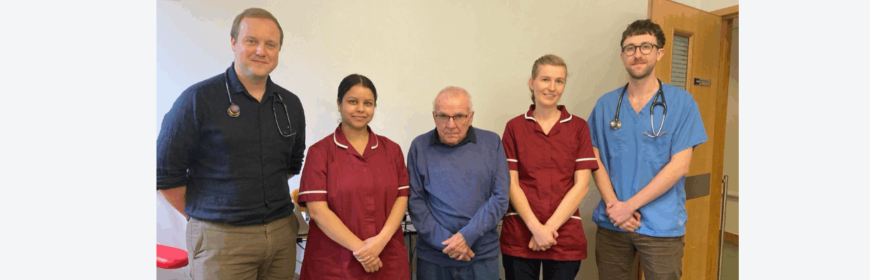 Patient James stands with Dr Nick Lane, research nurses Sarah Bhatti and Grace Fawcett, and Dr Joseph Cross