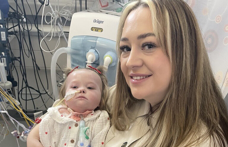 Close up image of baby Poppy in her mum Becca's arms in the PICU at the Freeman Hospital.