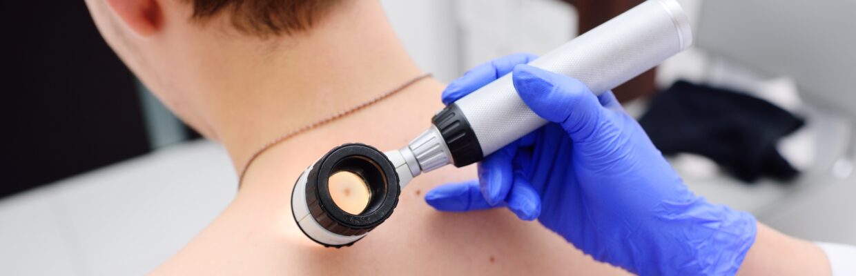 Clinician looking through a lens at a patient's skin