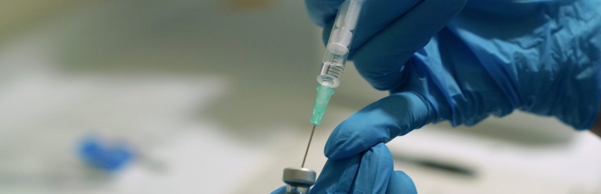 A needle is filled from a phial of Pfizer/BioNTech Covid-19 vaccine at the Royal Victoria Infirmary in Newcastle