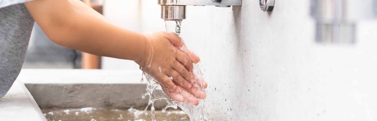 Banner of a student boy wash hands at the outdoor wash basin in the school. Preventing Contagious diseases, Plague. Kids health, Hygiene, Flu, H5N1 influenza, Saving water, Covid-19, New normal.