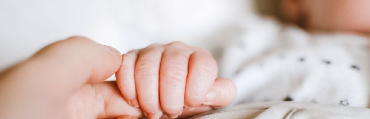 Image of baby holding hand