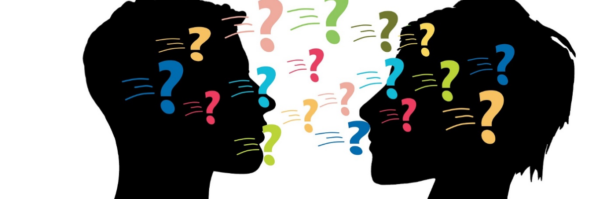 Silhouettes of two heads with different coloured question marks going between the two heads