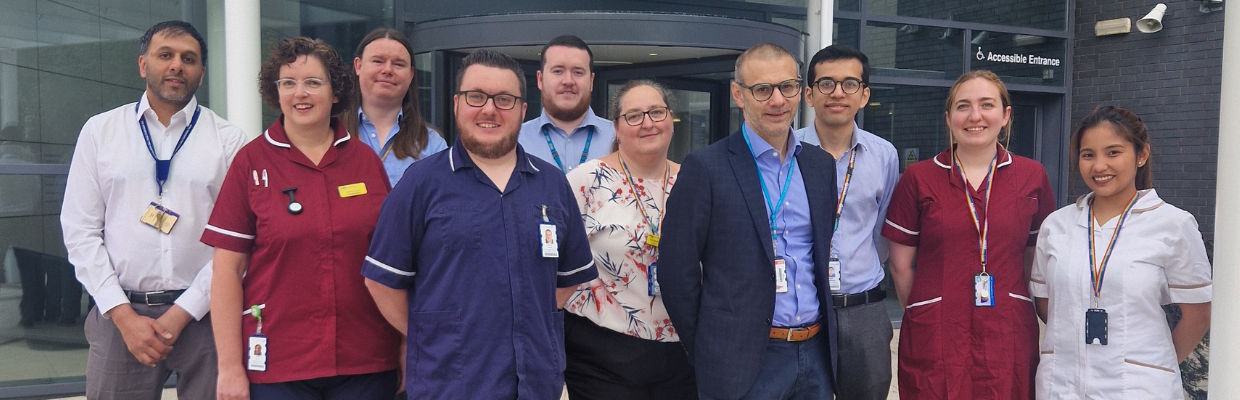 The team involved in recruiting the first patient in the world to a trial stand together outside a building