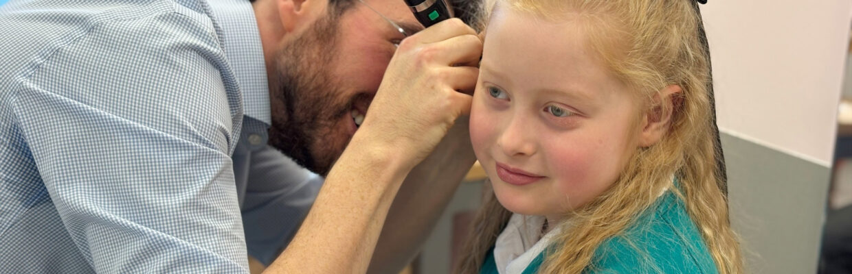 Mr Jason Powell checking Kayah Tulip's ears