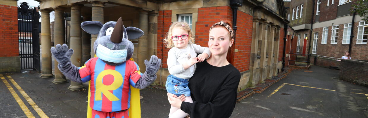 Mother and daughter are stood outside the RVI with Blaze, the research mascot
