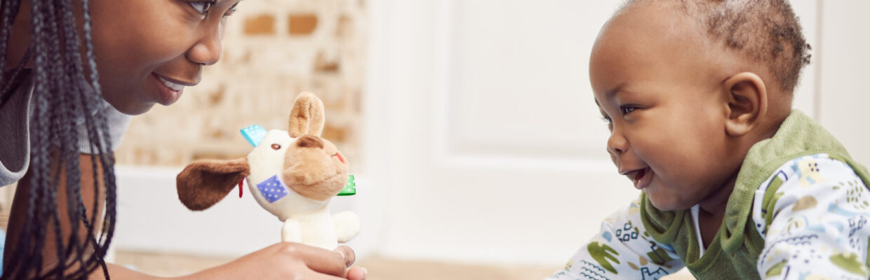 Tummy time is fun time. Shot of a young woman bonding with her baby at home.