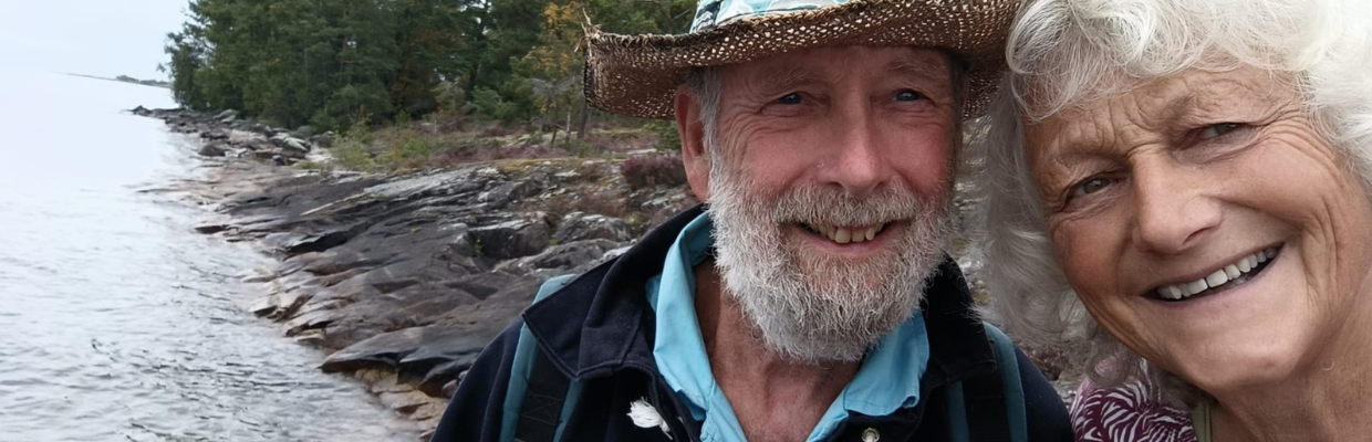Patient Chris Brown and his wife stand together in front a river in the background