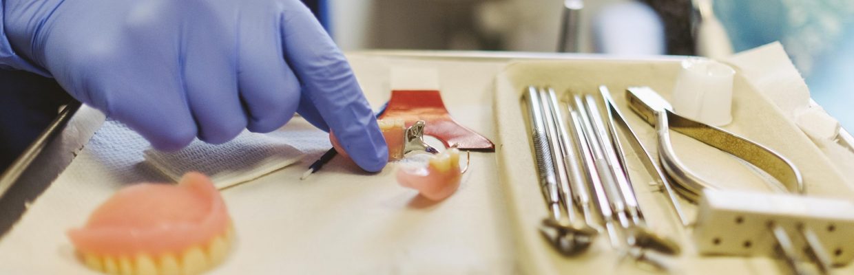 Image of dental clinician with instruments